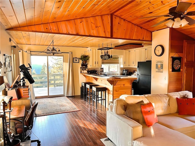 living room with lofted ceiling, dark wood-type flooring, wooden ceiling, and ceiling fan