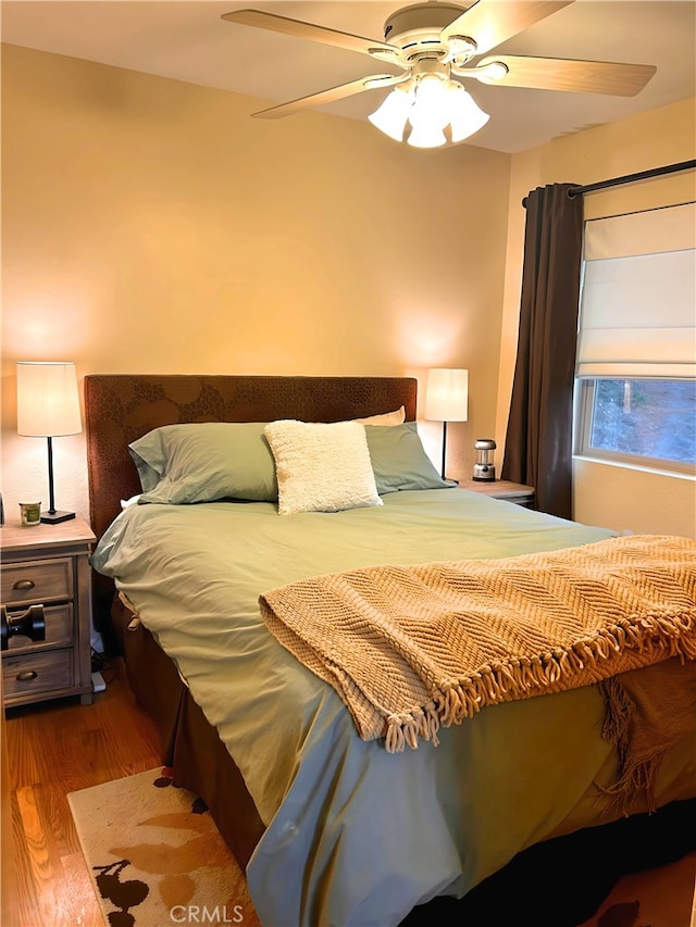 bedroom featuring ceiling fan and wood-type flooring