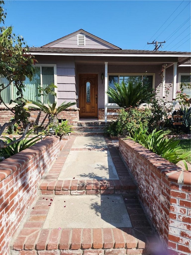 doorway to property with brick siding