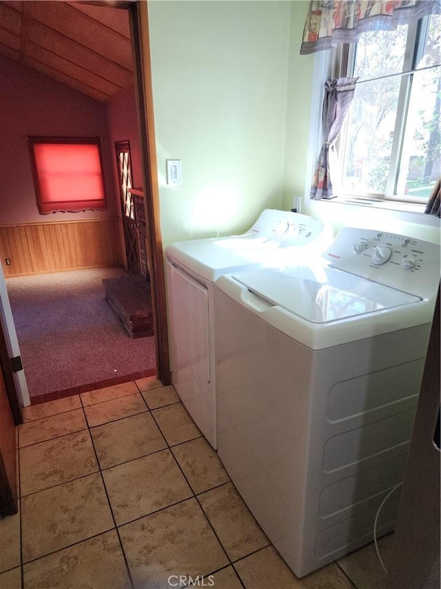 washroom with separate washer and dryer and light tile patterned flooring