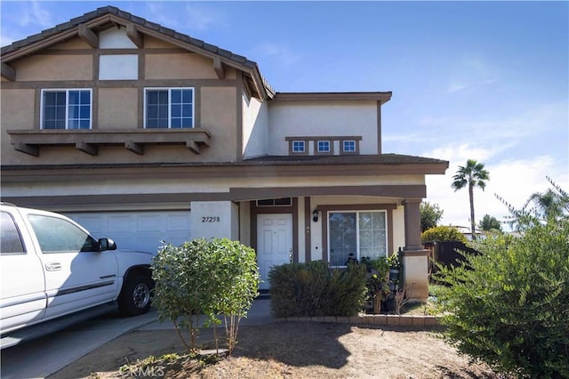 front of property featuring covered porch and a garage