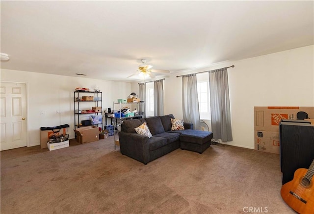 carpeted living room with ceiling fan