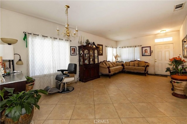 living room featuring light tile patterned floors and a notable chandelier