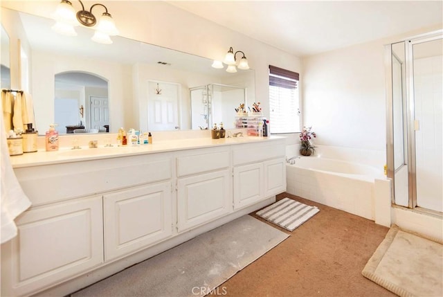 bathroom featuring plus walk in shower and vanity