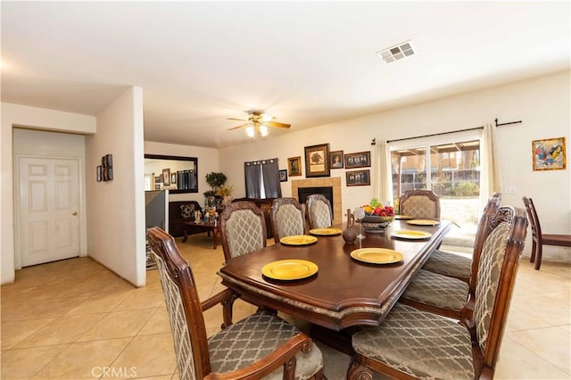 dining space featuring ceiling fan and light tile patterned flooring