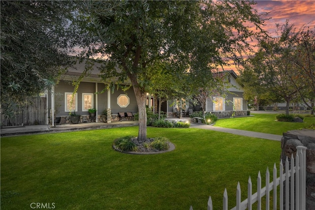 view of property hidden behind natural elements featuring a yard