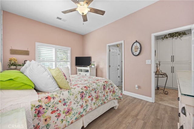 bedroom featuring light hardwood / wood-style floors and ceiling fan