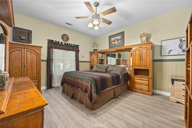 bedroom with light hardwood / wood-style flooring and ceiling fan