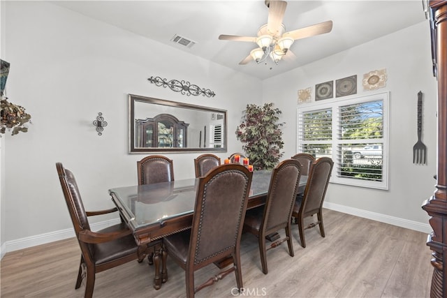 dining room featuring light hardwood / wood-style floors and ceiling fan