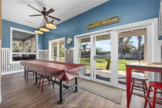 dining space with a wealth of natural light and dark hardwood / wood-style flooring