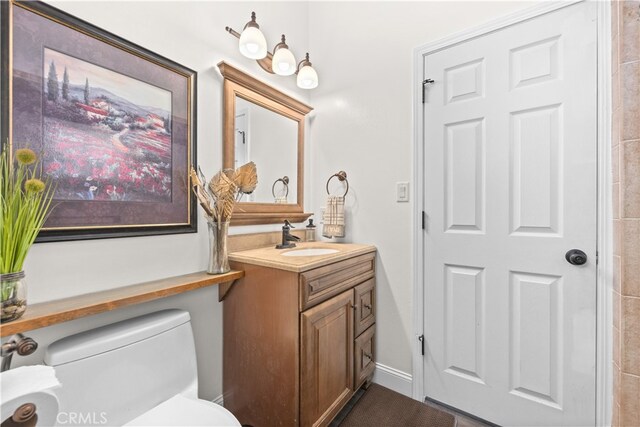 bathroom featuring vanity and toilet