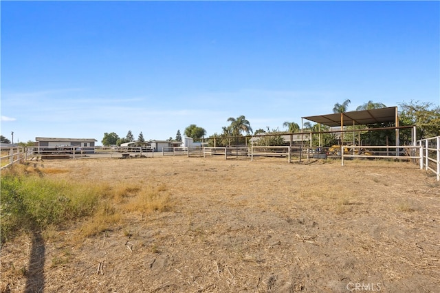 view of yard with an outdoor structure and a rural view