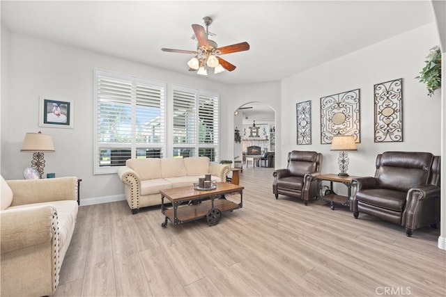 living room featuring ceiling fan and light hardwood / wood-style flooring