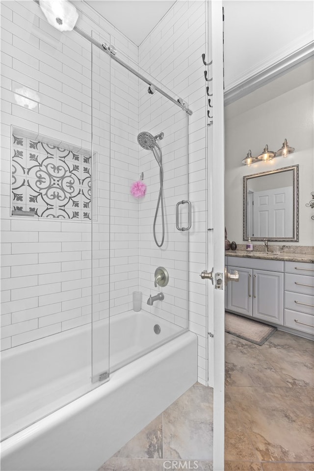 bathroom with vanity and combined bath / shower with glass door