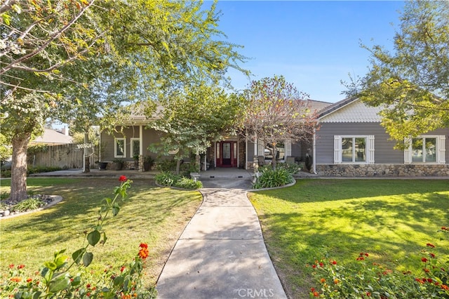 obstructed view of property with a front lawn