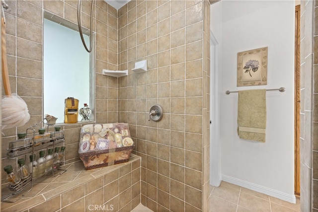 bathroom with tile patterned flooring and tiled shower