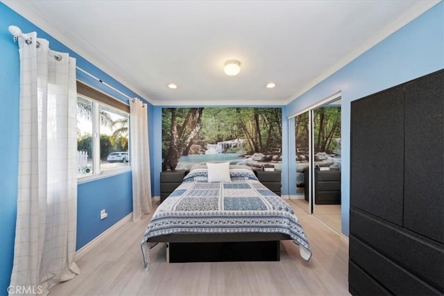 bedroom with light hardwood / wood-style floors and ornamental molding