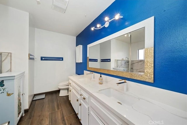 bathroom featuring hardwood / wood-style floors, vanity, and toilet