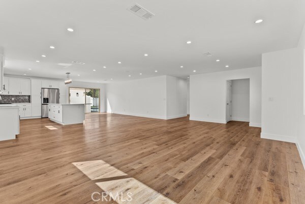 unfurnished living room with light hardwood / wood-style floors