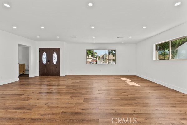 foyer entrance with a healthy amount of sunlight and light hardwood / wood-style flooring