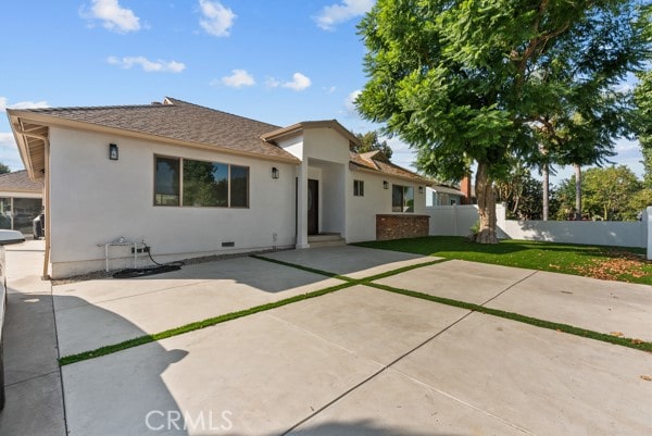 back of property with a patio