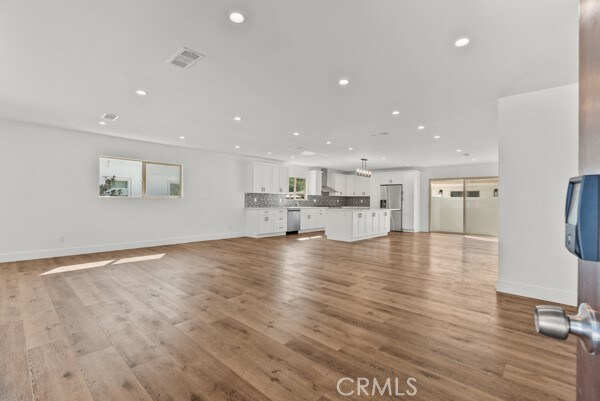 unfurnished living room featuring light wood-type flooring