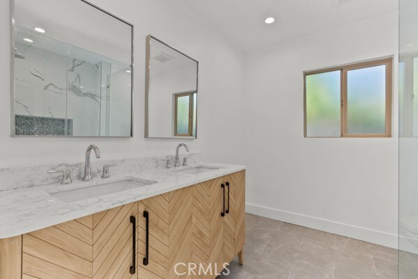 bathroom with vanity, tile patterned flooring, and an enclosed shower