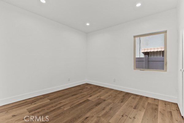 unfurnished room featuring hardwood / wood-style floors