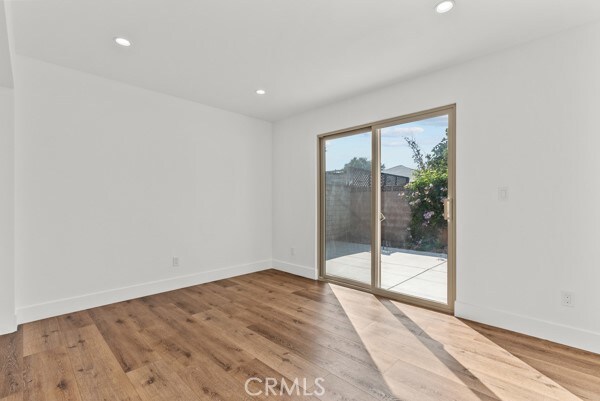 unfurnished room with hardwood / wood-style flooring