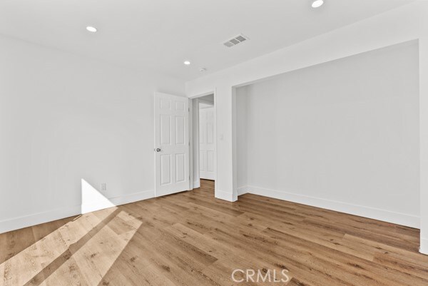 spare room featuring light wood-type flooring