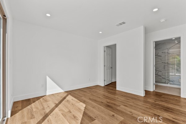 unfurnished room featuring hardwood / wood-style floors