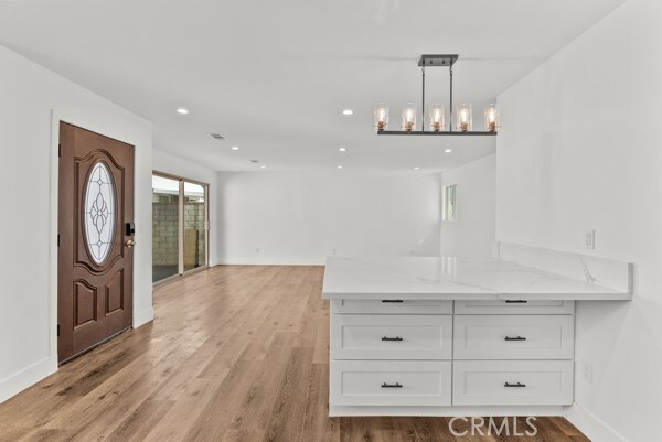 entryway with a chandelier and light hardwood / wood-style floors