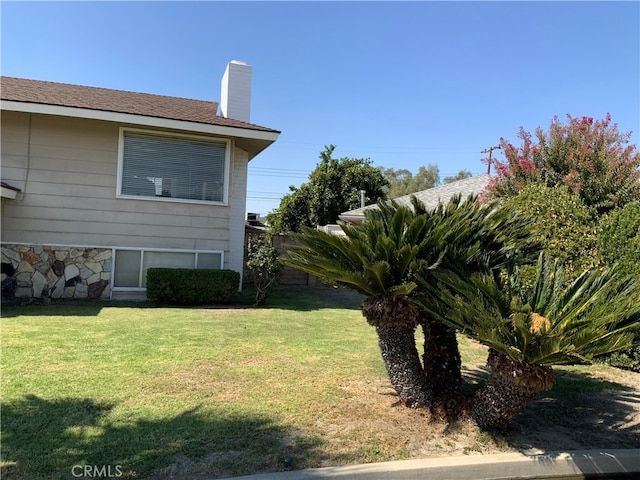 view of side of home with a lawn