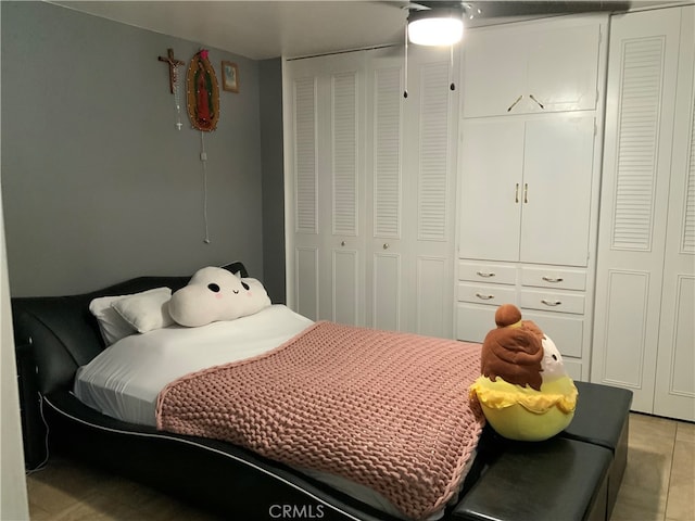 tiled bedroom featuring ceiling fan