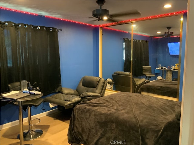 bedroom with wood-type flooring and ceiling fan