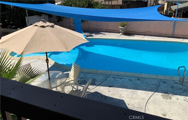 view of swimming pool with a patio area