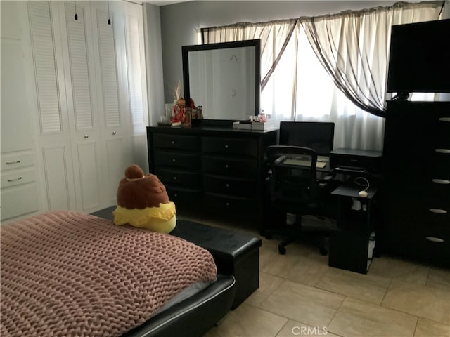 bedroom featuring light tile patterned flooring and a closet