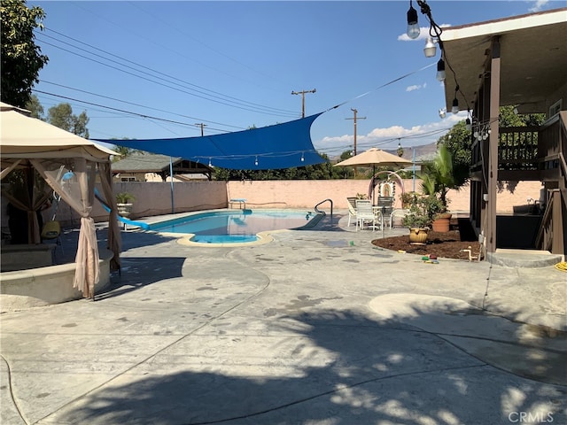 view of swimming pool with a gazebo and a patio area