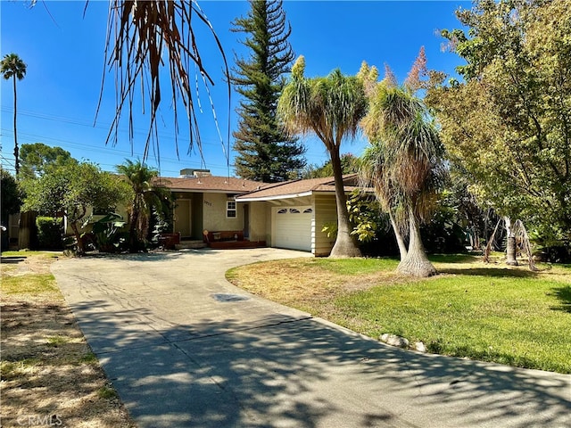 view of front of home with a garage and a front yard