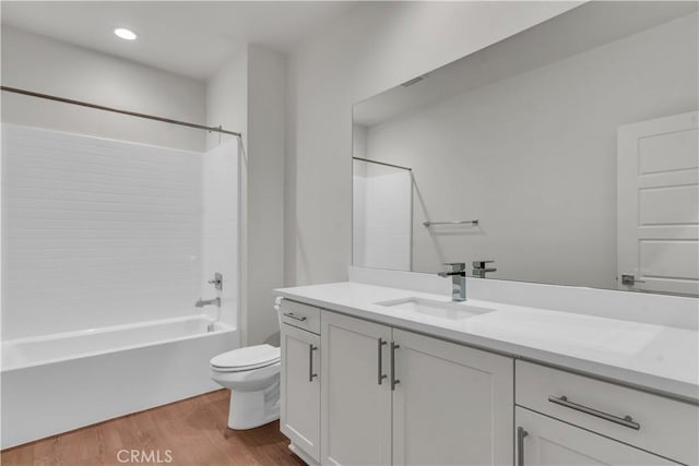 full bathroom featuring vanity, toilet, shower / bathing tub combination, and hardwood / wood-style flooring