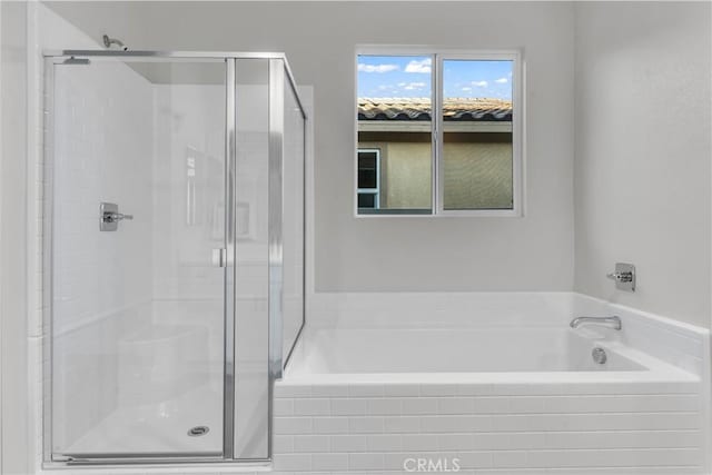 bathroom with separate shower and tub