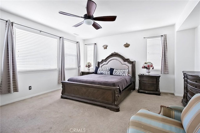 carpeted bedroom with multiple windows and ceiling fan