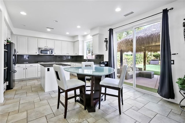 kitchen with white cabinetry, sink, appliances with stainless steel finishes, and tasteful backsplash