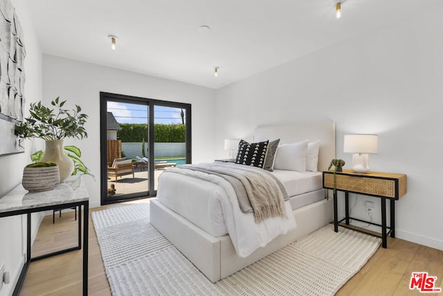 bedroom featuring access to outside and light hardwood / wood-style flooring