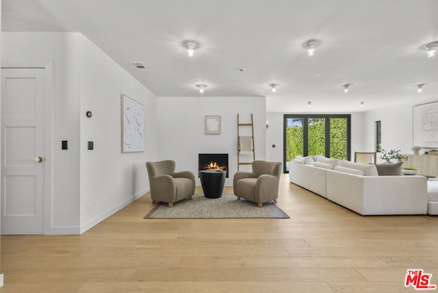 living room with light hardwood / wood-style flooring