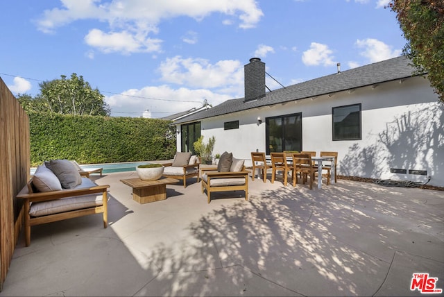 view of patio / terrace with a fenced in pool and an outdoor hangout area