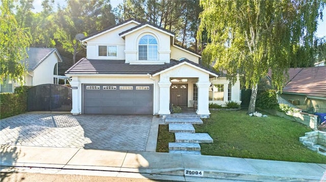 view of front of property with a garage and a front yard