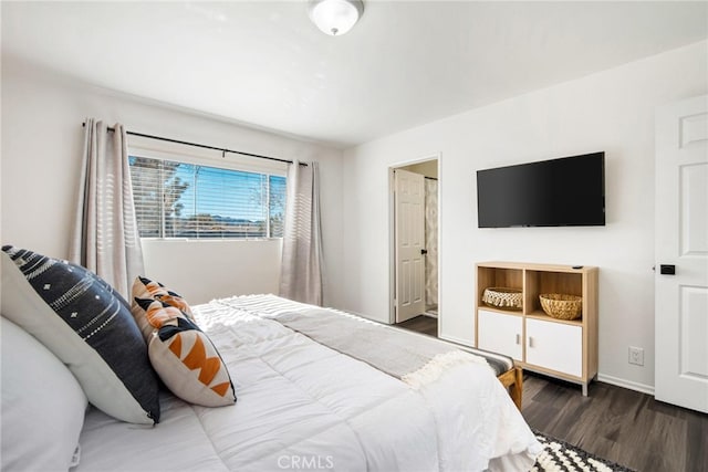 bedroom with dark hardwood / wood-style flooring