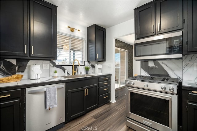 kitchen featuring backsplash, dark hardwood / wood-style floors, sink, and stainless steel appliances