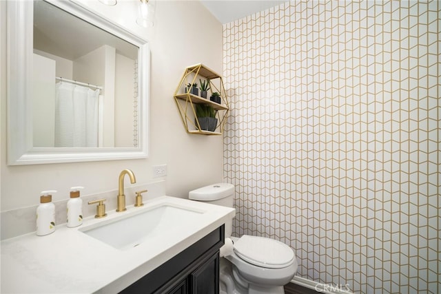 bathroom with vanity, toilet, and a shower with curtain